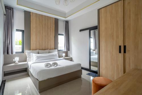 a bedroom with a bed with two wedding rings on it at BRAND-NEW! The Private PoolVilla /4BR byน้องมังคุด in Nong Prue