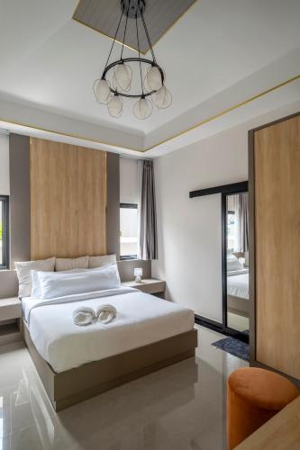a bedroom with two wedding rings on a bed at BRAND-NEW! The Private PoolVilla /4BR byน้องมังคุด in Nong Prue