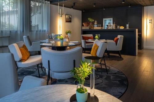 a dining room with tables and chairs and tablesktop at Le Domaine Du Colombier in Malataverne