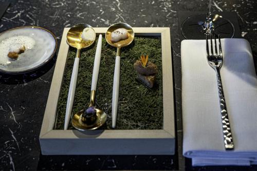 a tray with three spoons and a fork and a plate at Le Domaine Du Colombier in Malataverne