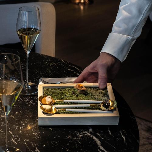 a person is reaching for a box of chopsticks at Le Domaine Du Colombier in Malataverne