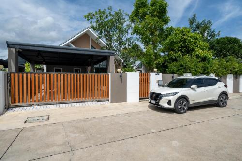 a white car parked in front of a house at BRAND-NEW! The Private PoolVilla /4BR byน้องมังคุด in Nong Prue