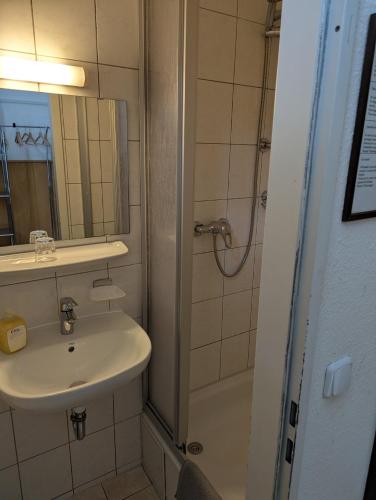 a bathroom with a sink and a shower at Hotel Pension Waizenegger am Kurfürstendamm in Berlin