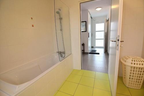 a bathroom with a tub and a walk in shower at Les jardins de kerarzic in Ploubazlanec