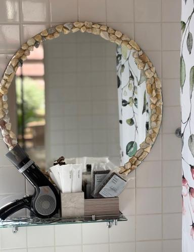a mirror on a shelf in a bathroom at AGASA residence in Fujieda