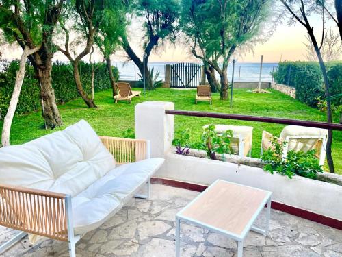 a patio with a couch and chairs and a table at La Porta sul Mare in Terracina