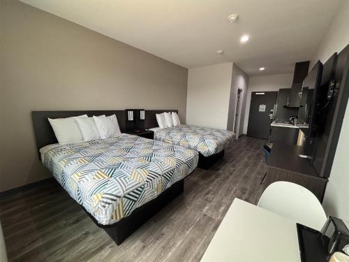 a hotel room with two beds and a kitchen at Studio 6 Giddings in Giddings