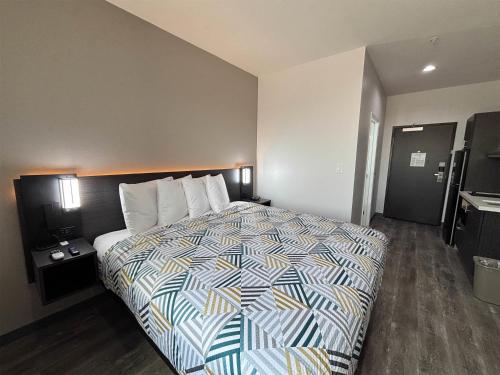 a bedroom with a bed in a hotel room at Studio 6 Giddings in Giddings
