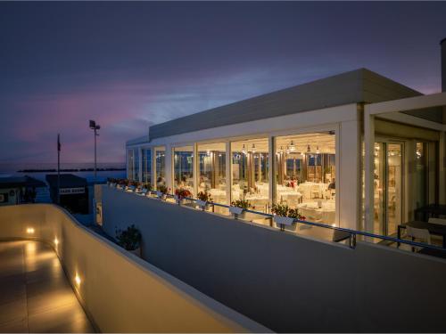 a balcony of a building with tables and chairs at Nautilus Family Hotel in Pesaro
