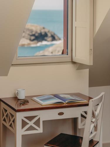 a desk with a window and a book on it at Le Grand Large, Belle-Ile-En-Mer in Bangor