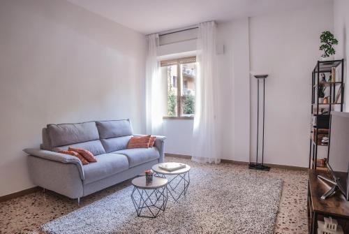 a living room with a couch and a table at Scandicci Flat - 15 mins from Florence in Scandicci