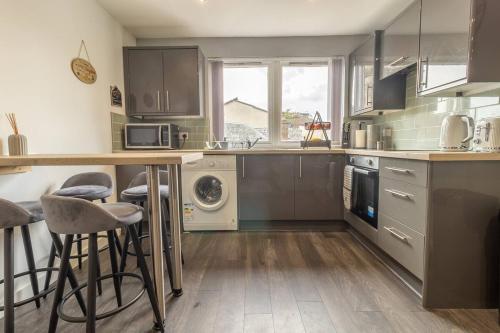 a kitchen with a counter and some stools in it at The Loft - 3 bedroom in Crieff in Crieff