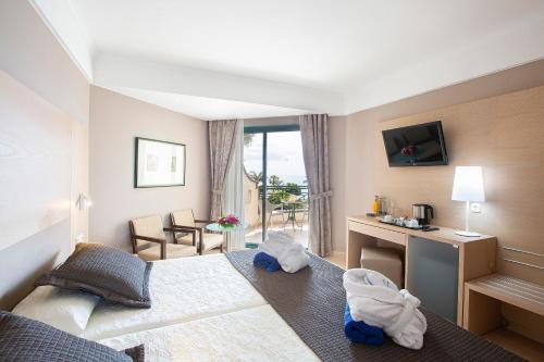 a hotel room with a bed and a desk at Hipotels Natura Palace Adults Only in Playa Blanca