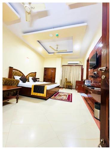 a hotel room with a bed and a tv at Power Onn Grand Cuttack Residency in Cuttack