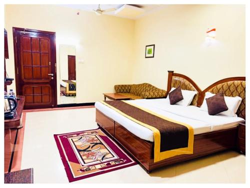 a bedroom with a bed in a room with a door at Power Onn Grand Cuttack Residency in Cuttack