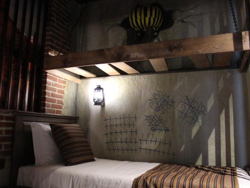 a bed in a room with a wooden bed frame at Gardaland Adventure Hotel in Castelnuovo del Garda