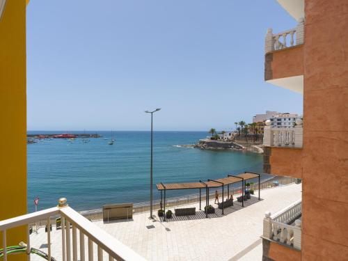 a view of the ocean from a balcony at Marañuelas Beach Suites Arguineguin in Arguineguín
