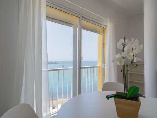 a room with a large window with a view of the ocean at Marañuelas Beach Suites Arguineguin in Arguineguín