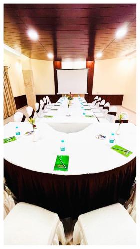 a large meeting room with a long table with chairs at Power Onn Grand Cuttack Residency in Cuttack