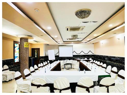 a conference room with a white table and chairs at Power Onn Grand Cuttack Residency in Cuttack