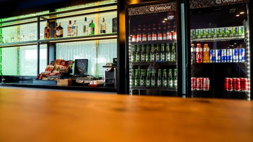 a bar with a lot of bottles of soda at Ibis Styles Macaé in Macaé