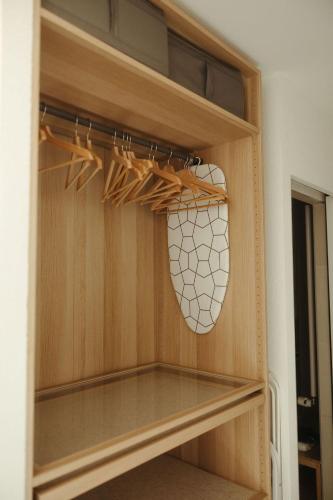 a closet with wooden shelves and a net at "La Maisonnette" Cozy tiny house close to Montreux in Villeneuve