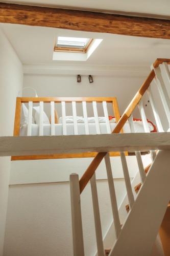 a loft bed with a staircase in a room at "La Maisonnette" Cozy tiny house close to Montreux in Villeneuve