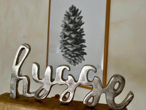a metal sign that says aging on top of a table at B&B Apart Hotel Goldener Hahn - Hygge Pool & Sauna in Baiersbronn