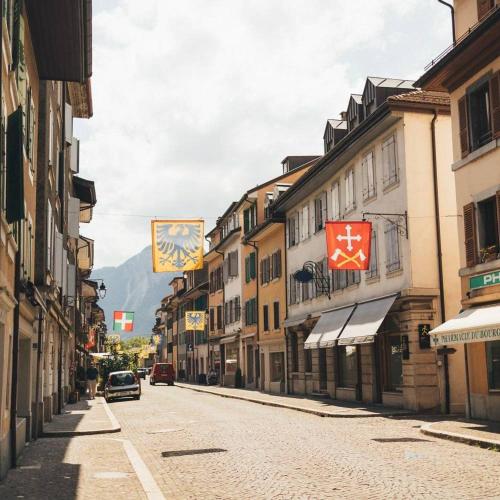 an empty street in a city with buildings at "La Maisonnette" Cozy tiny house close to Montreux in Villeneuve