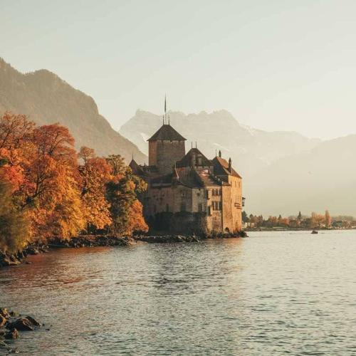 a large building on an island in the water at "La Maisonnette" Cozy tiny house close to Montreux in Villeneuve