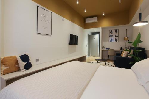 a bedroom with a bed and a living room at cvm 19 in Milan