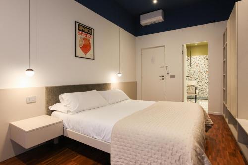 a bedroom with a large white bed and a door at cvm 19 in Milan