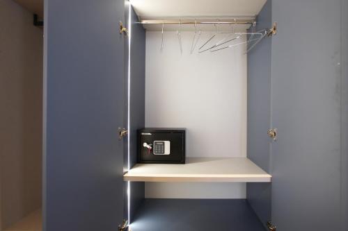 a walk in closet with a black box on a shelf at cvm 19 in Milan