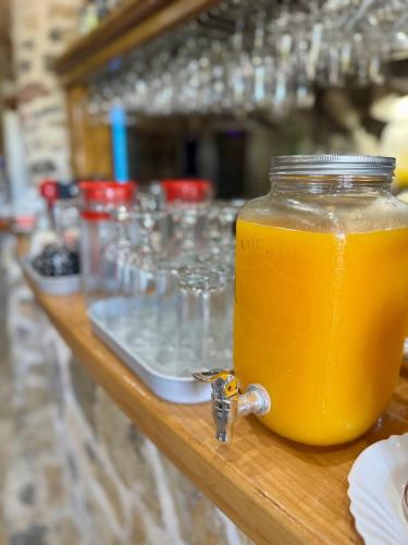 a jar of orange juice sitting on a table at Kangaroo Apartmani in Prijevor