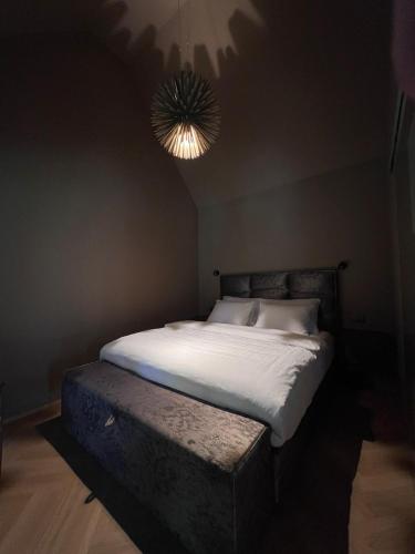 a bed in a dark room with a light at Glamping house Mala 
