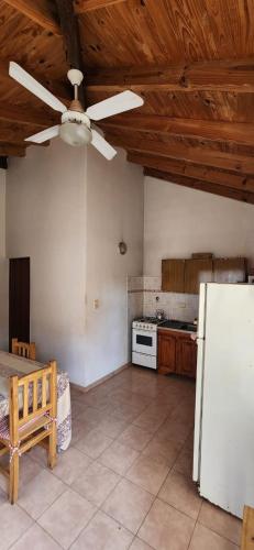 a kitchen with a ceiling fan and a refrigerator at Mi Casita in Colón