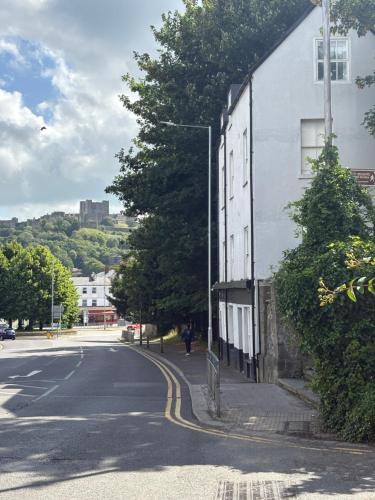 a white building on the side of a street at Alma House in Dover