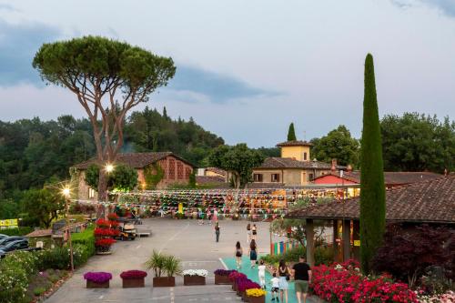 a group of people walking around a courtyard at Villa Norcenni ApartHotel in Figline Valdarno