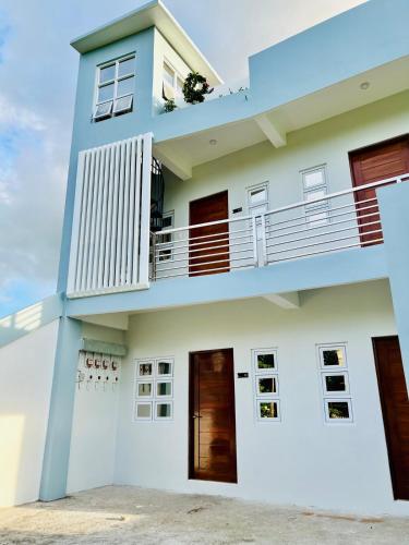 a house with a balcony in front of it at Cozy 1-Bedroom Unit in Ligao City, Albay in Tuburan