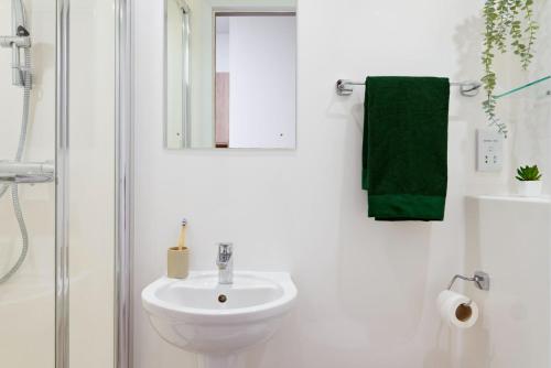 a white bathroom with a sink and a shower at For Students Only - Student Castle Reading in Reading