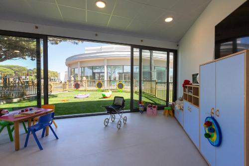 a room with a table and chairs and a large window at Hipotels Barrosa Park in Chiclana de la Frontera