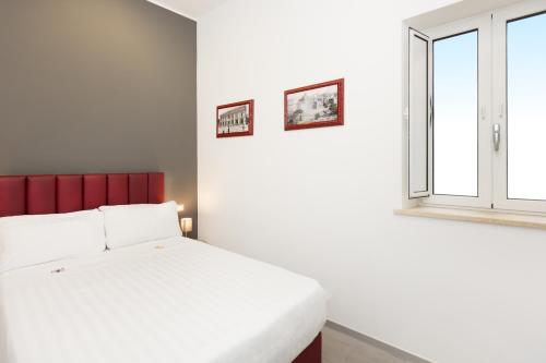 Un ou plusieurs lits dans un hébergement de l'établissement Hotel Castellino Roma