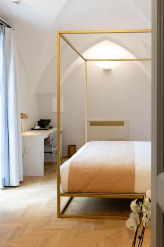 a bedroom with a bed with a glass canopy at Palazzo Zimara Boutique Hotel in Lecce