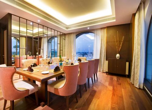 a large dining room with a long table and chairs at Radisson Blu Plaza Hotel Mysore in Mysore