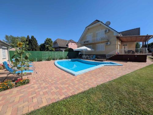 a backyard with a swimming pool and a house at Holiday home in Siofok - Balaton 19638 in Siófok