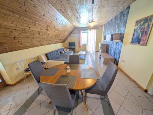 a living room with a table and chairs and a couch at Holiday home in Siofok - Balaton 19638 in Siófok