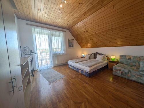a bedroom with a bed and a wooden ceiling at Holiday home in Siofok - Balaton 19638 in Siófok