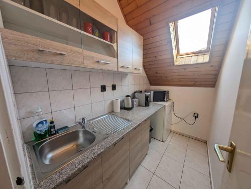 a small kitchen with a sink and a window at Holiday home in Siofok - Balaton 19638 in Siófok