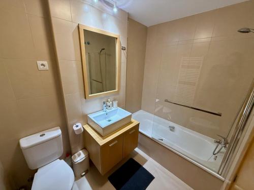 a bathroom with a toilet and a sink and a shower at Charming apartment with a pool and golf view in Sucina