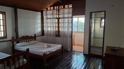 Katil atau katil-katil dalam bilik di Pousada da Tia penha